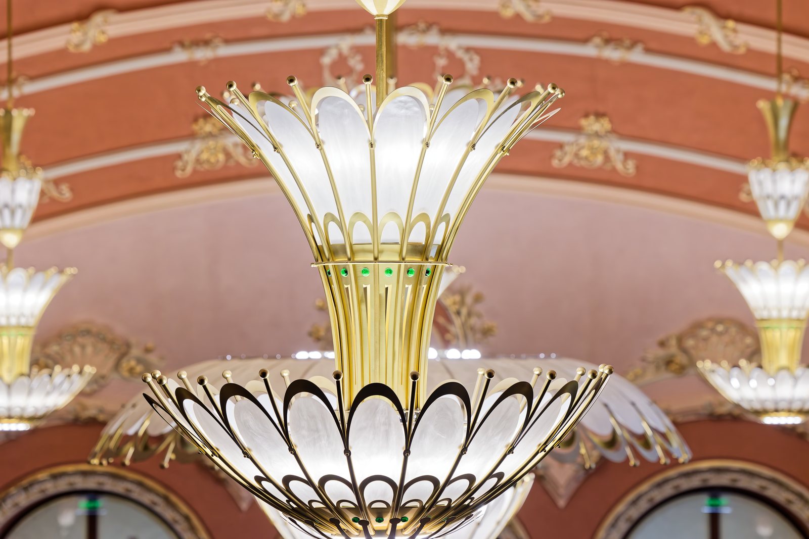 Detail of the Art Nouveau chandelier, with its brass corolla and opal glass petals