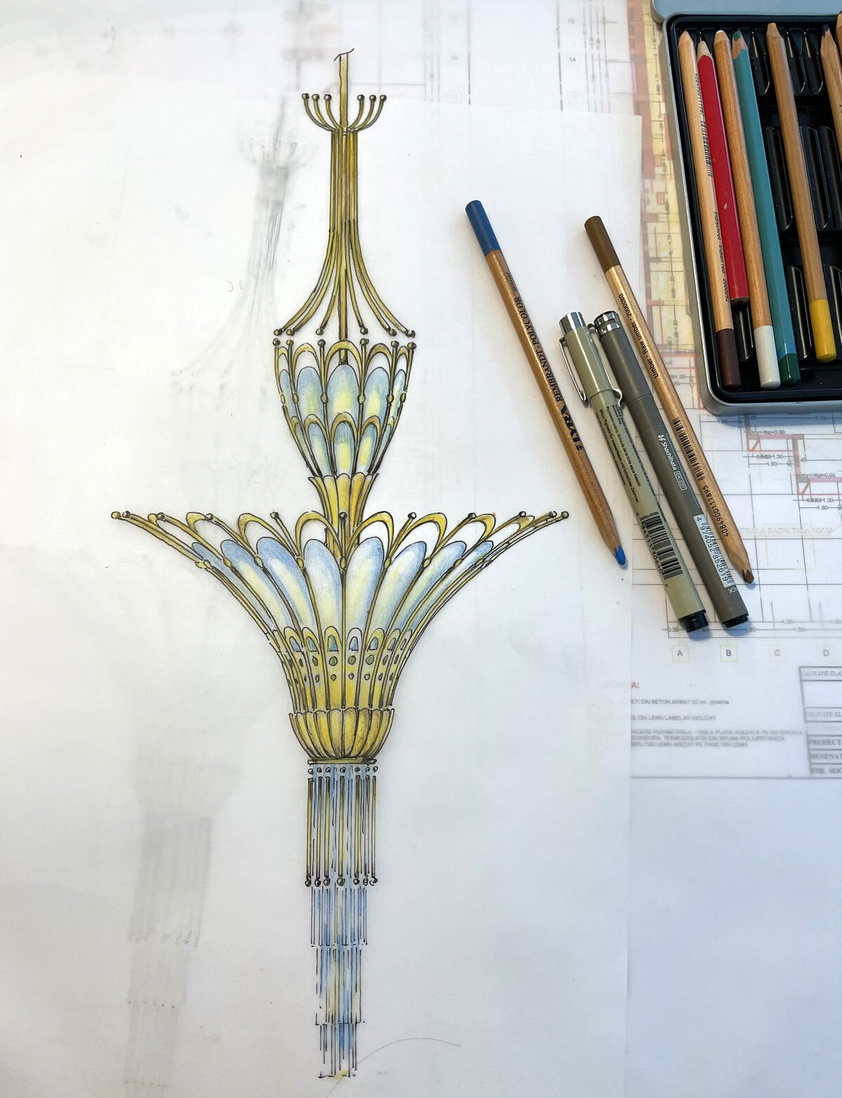 Colour sketch of an Art Nouveau wall sconce, with pencils beside it