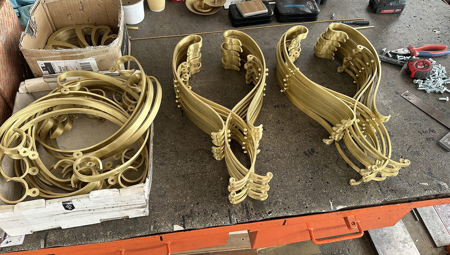 Brass volutes stacked on the workbench
