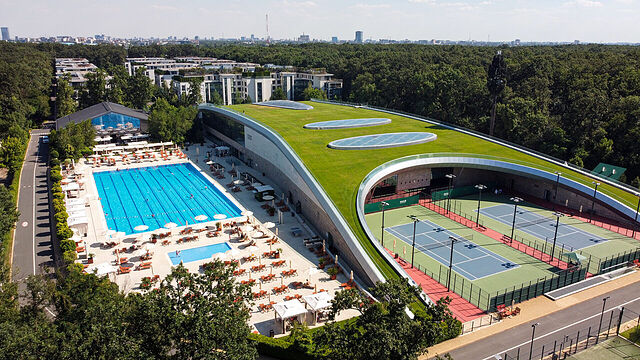 Aerial view of Stejarii Country Club in the Baneasa forest: the green roof, the outdoor pool and the tennis courts